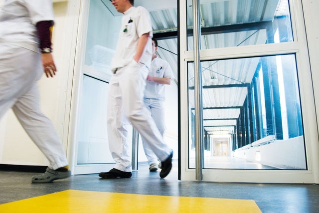 Men walking out of hospital room