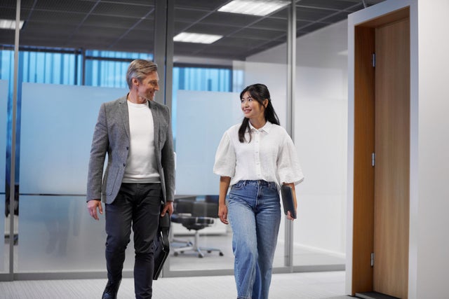 Man and woman walking in an office