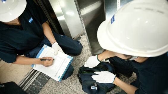 maintenance workers taking notes