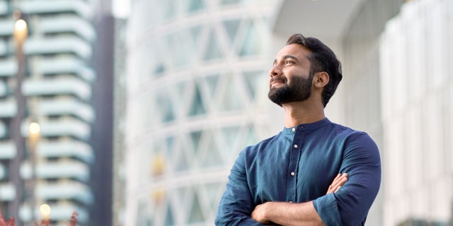 Man smiling in city environment