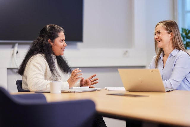 Two people discussing at an office