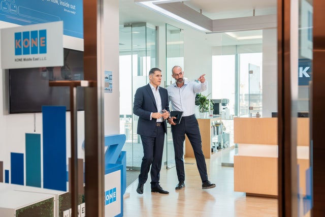 Two men standing in an office.