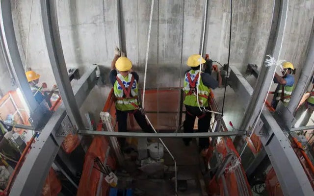 Elevator contruction site with workers