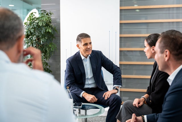 Businesspeople gathered in an office room.