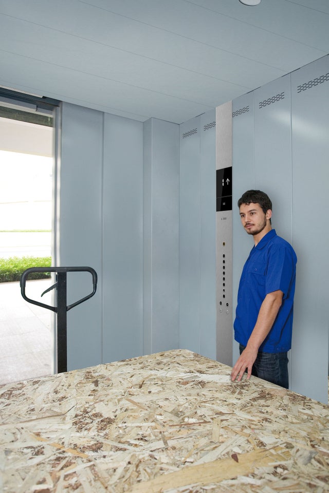 Man with forklift and cargo in elevator
