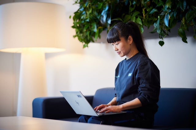 KONE employee looking at laptop