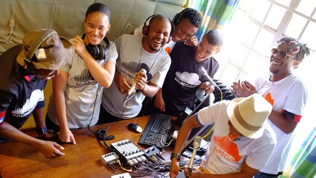 A group of people gathered together to sing with microphones.