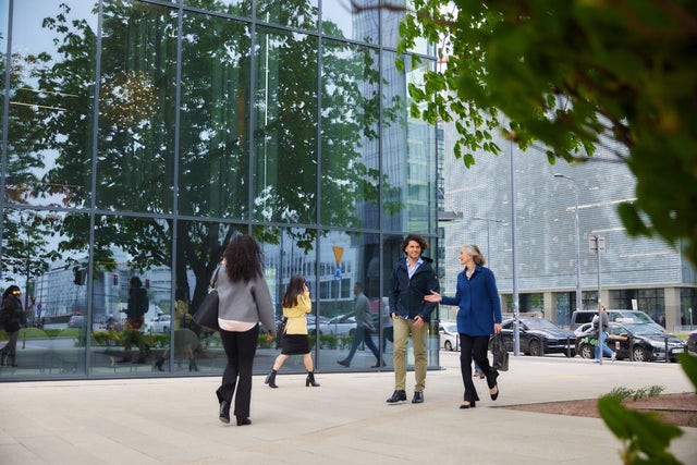 People walking in front of tall buildings