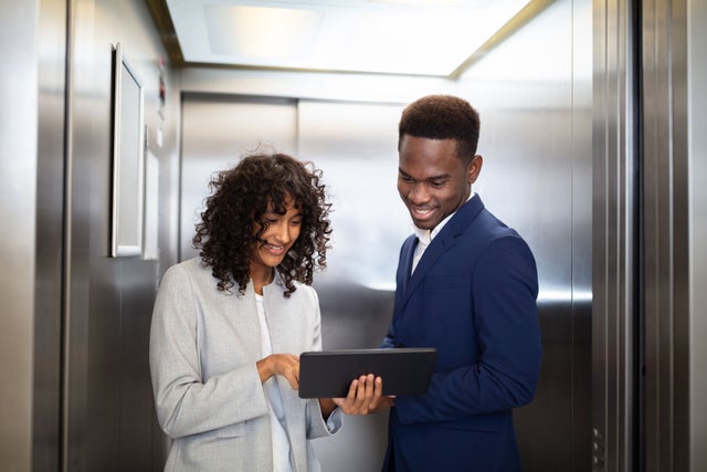 Businesspeople  standing inside elevator