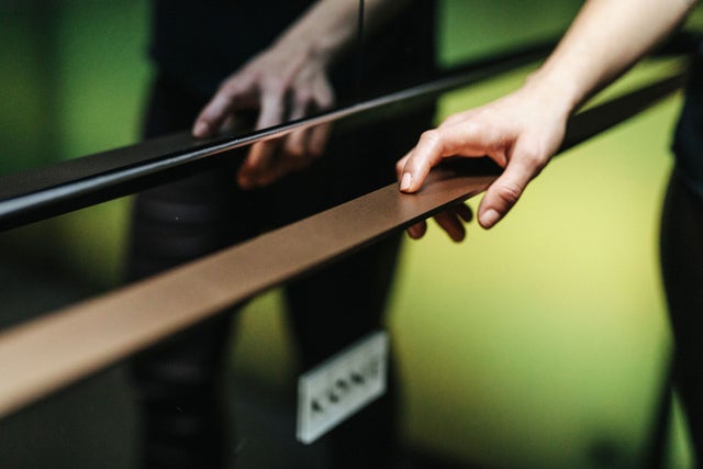 Hand on an elevator hand rail