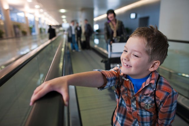 Child travelling on a moving walk