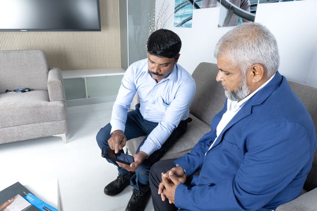 Man with mobile phone sitting on a sofa