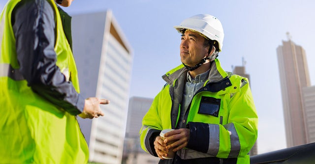 Construction site workers discussing