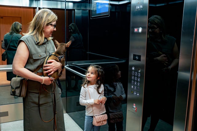 woman and child with dog in elevator in Karlatornet