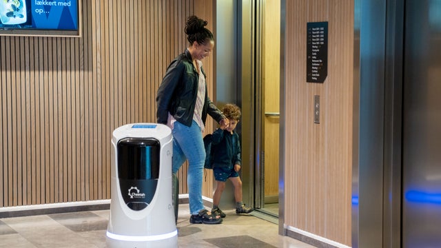 Mother and child going into an elevator