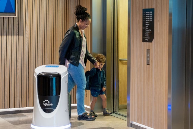 woman and child walking into an elevator