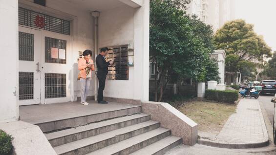 Couple coming out of a building
