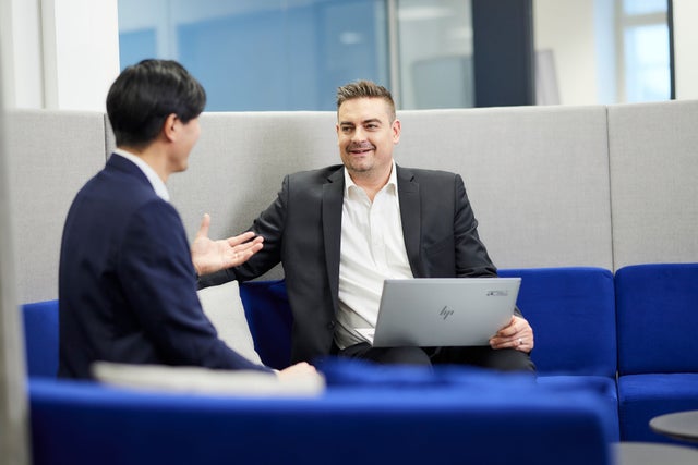 Two men in an office discussing