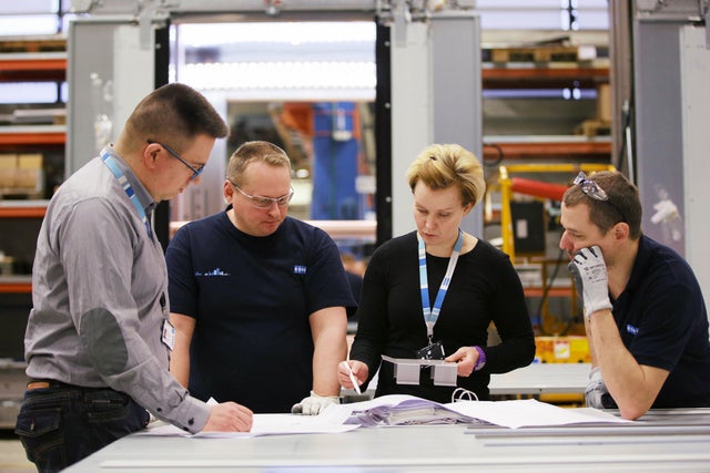 A group of people in Hyvinkää reviewing plans.