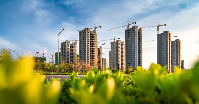 Skyline of high-rise buildings and cranes.