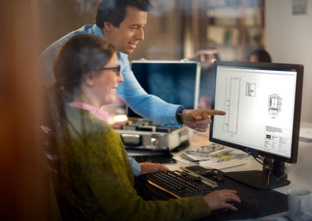 Man and woman looking at computer screen with elevator design
