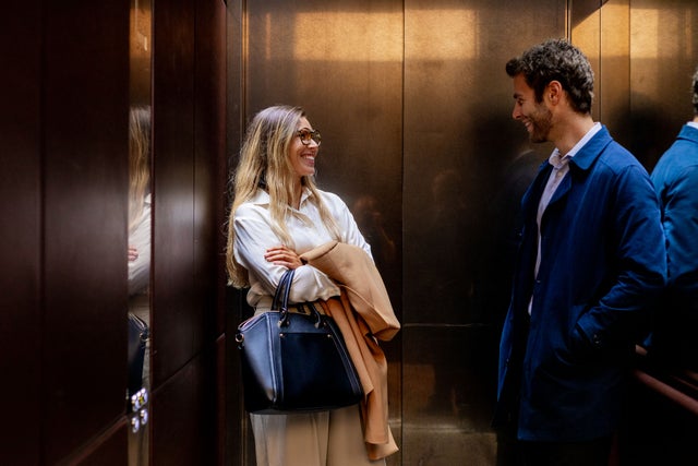 Two people inside an elevator