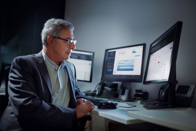 Man looking at multiple screens