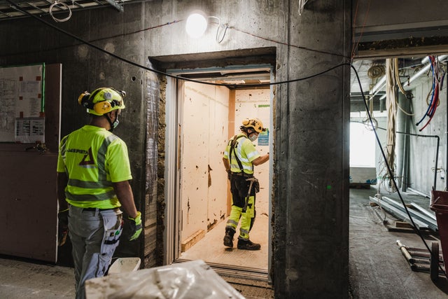 Two workers at a construction site.