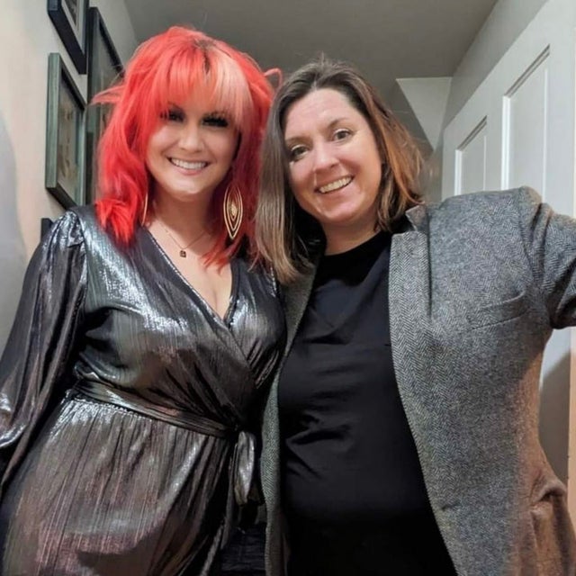 Two women smiling and looking into the camera