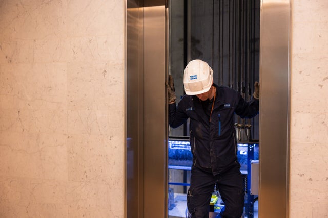 Technician exiting outside the elevator