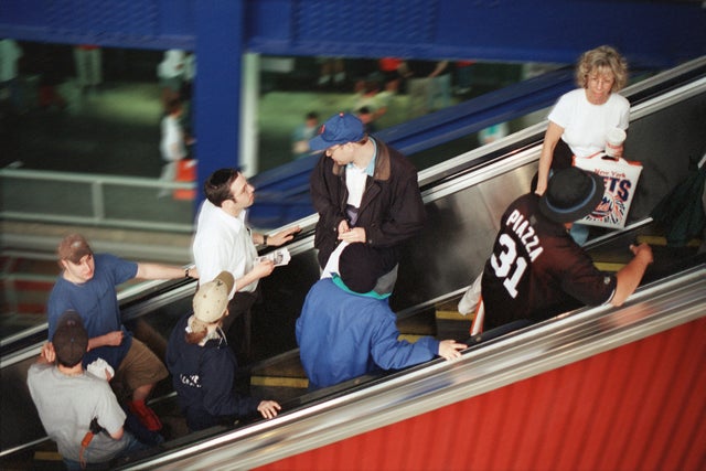 People going up on an escalator.